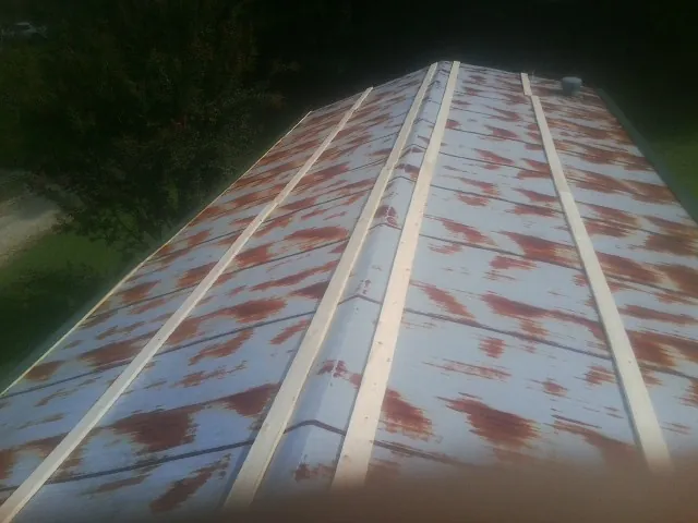 Rusted metal roof panels with new wood purlins before replacement — Storm Damage Roof Repair in Oley by Roofing Brothers