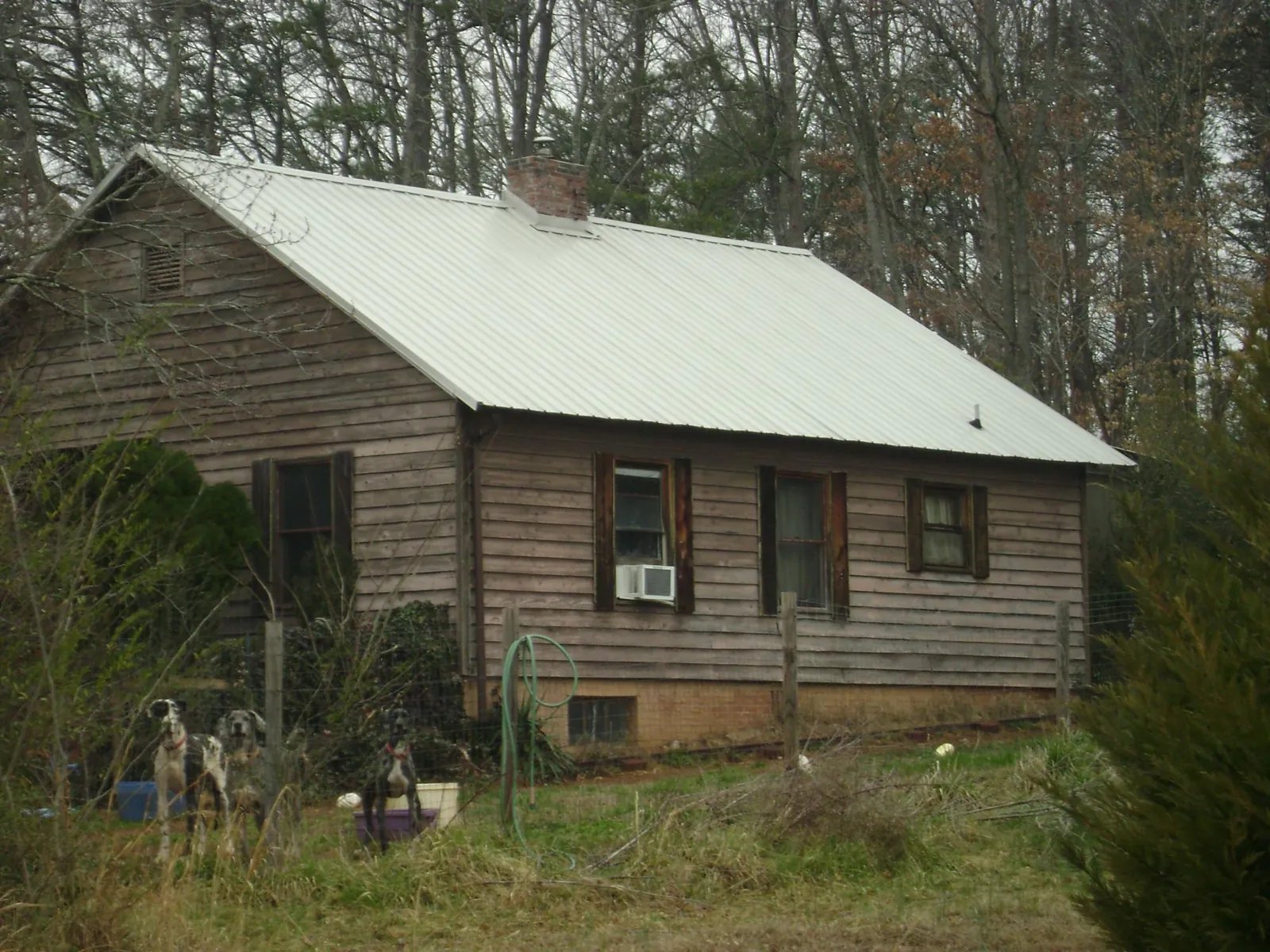 White metal roof on an old wood sided farmhouse, from a Metal Roof Installation job in Oley